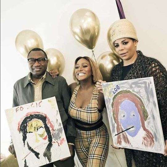 Photo Of The Day: DJ Cuppy’s parents paint a portrait of her