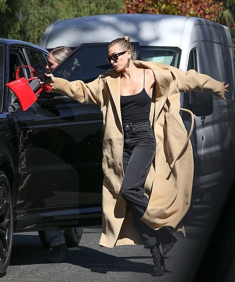 Hailey Bieber almost takes a tumble in towering heels while out with a friend