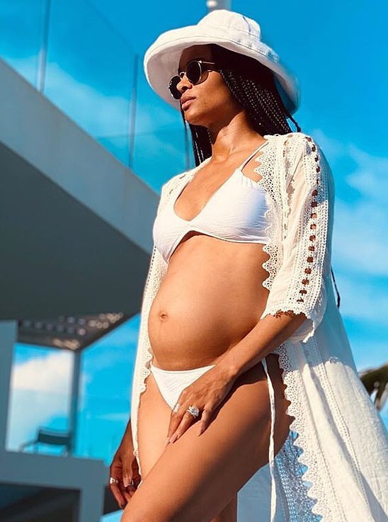 Ciara dares to bare her growing baby bump in white bikini