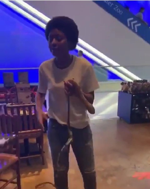 Regina Dnaiels playing with live  snake in Dubai on vacation