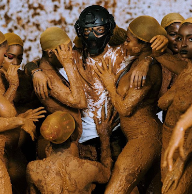 Singer Tekno poses with semi-n3de women ONLY covered in mud (photo)