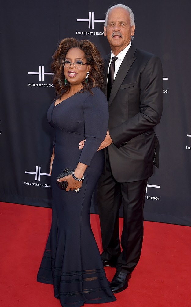 65 year-old Oprah Winfrey does a prom pose with beau