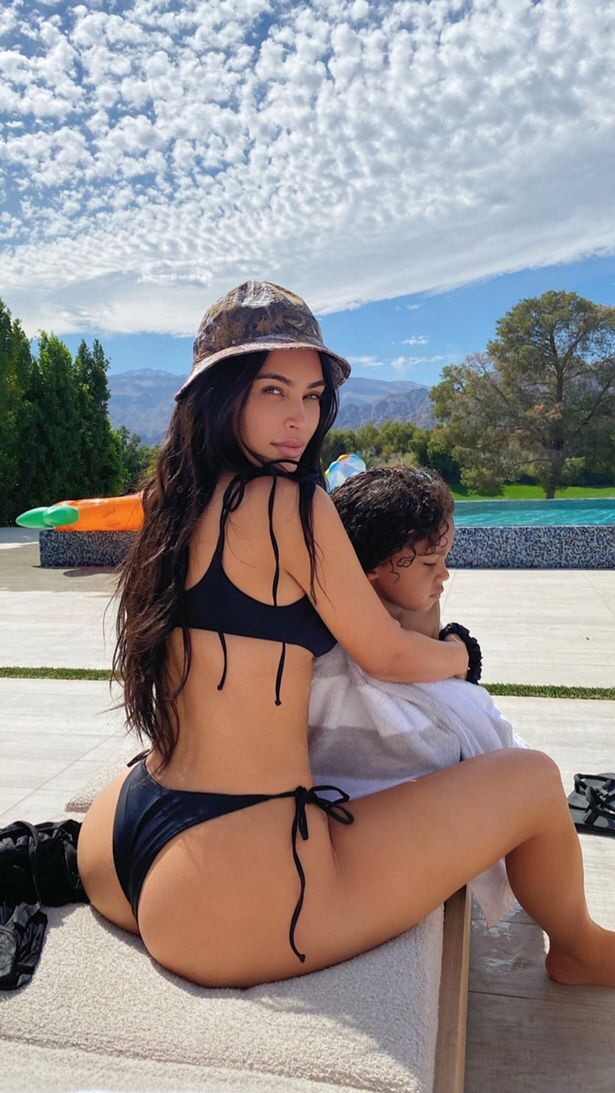 Kim Kardashian shows off bikini-clad bum as she poses with son