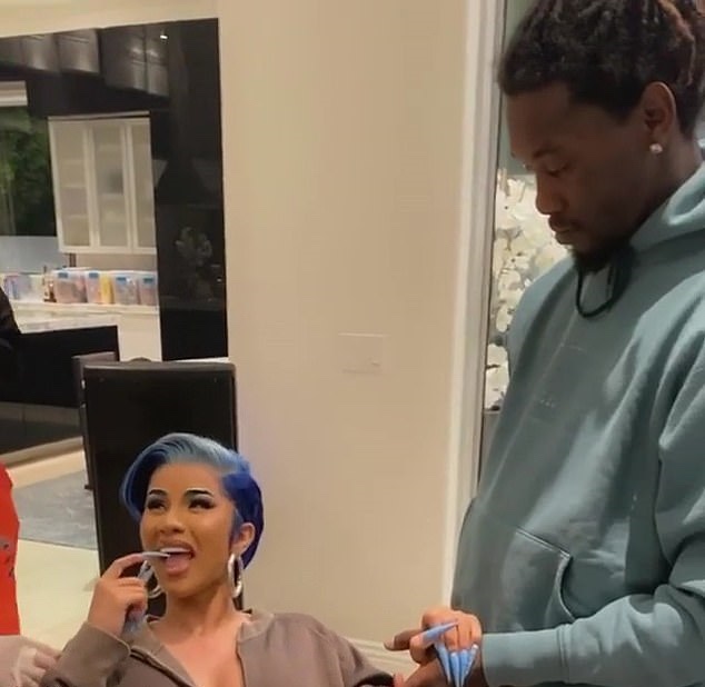 Cardi B holds Offset’s hand as she gets sternum piercings